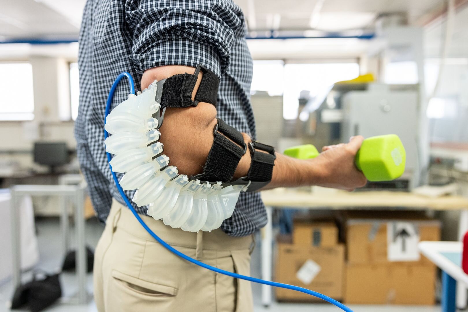 Pneumatically actuated, soft wearable robotic elbow exoskeleton for reducing muscle activity and perceived workload